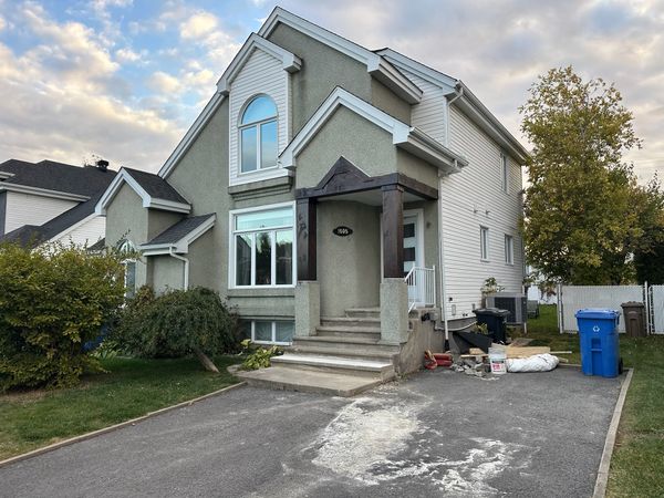 Professional spray painted home exterior in Alberta