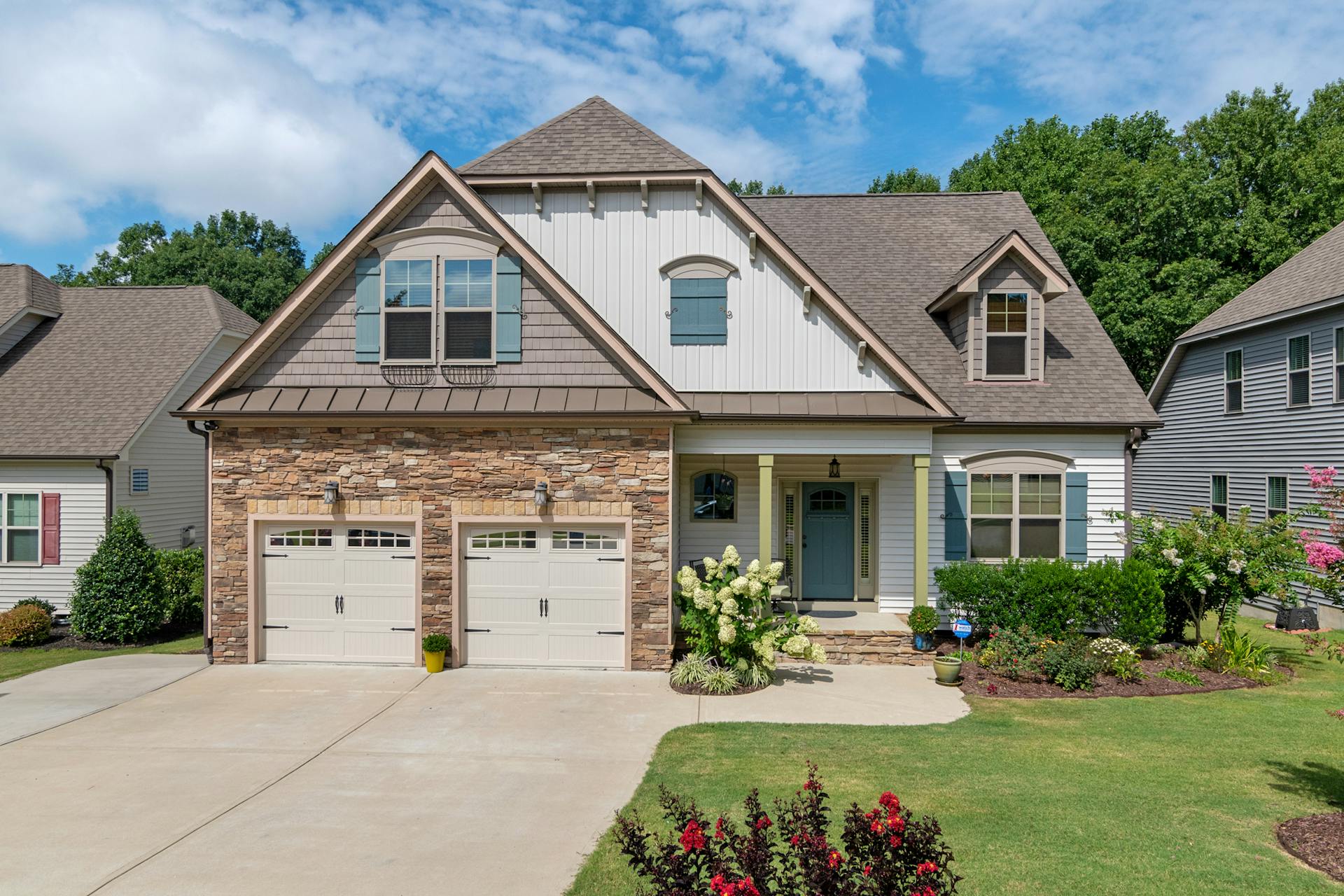 Suburban home with clean painted double garage doors